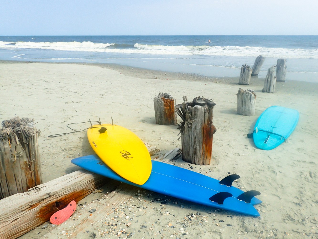 surfboards lying on a sandy beach